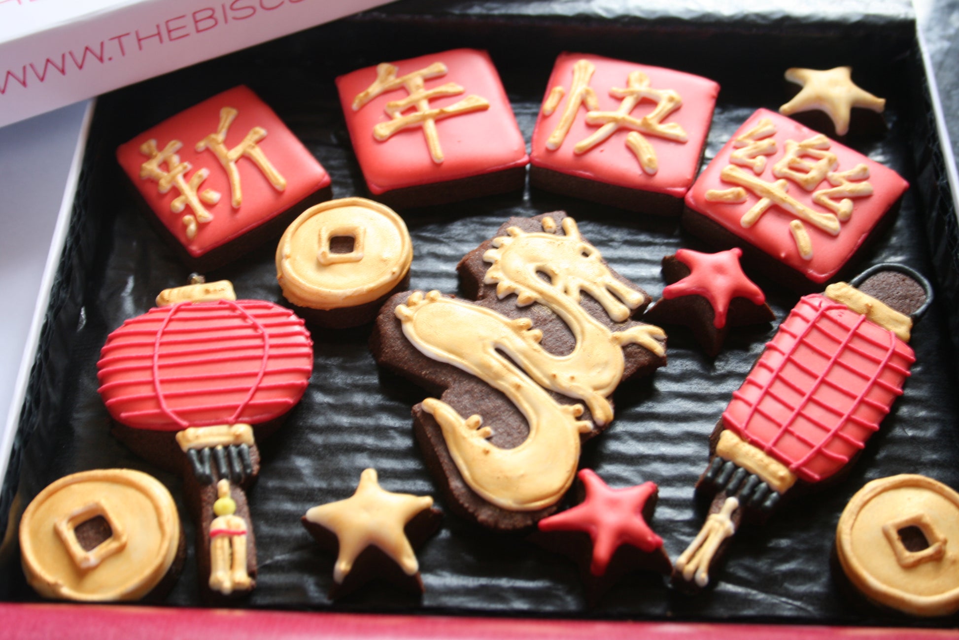 bespoke biscuits and custom cookies. Chinese new year cookies. Chinese dragon biscuits. red and gold cookies with Chinese dragon and new year symbols