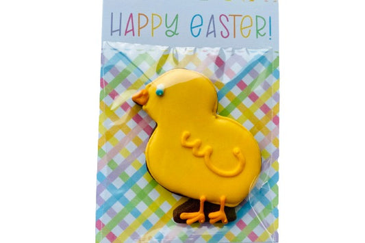 a little yellow chick shaped biscuit in cellophane and attached to an Easter cookie card.