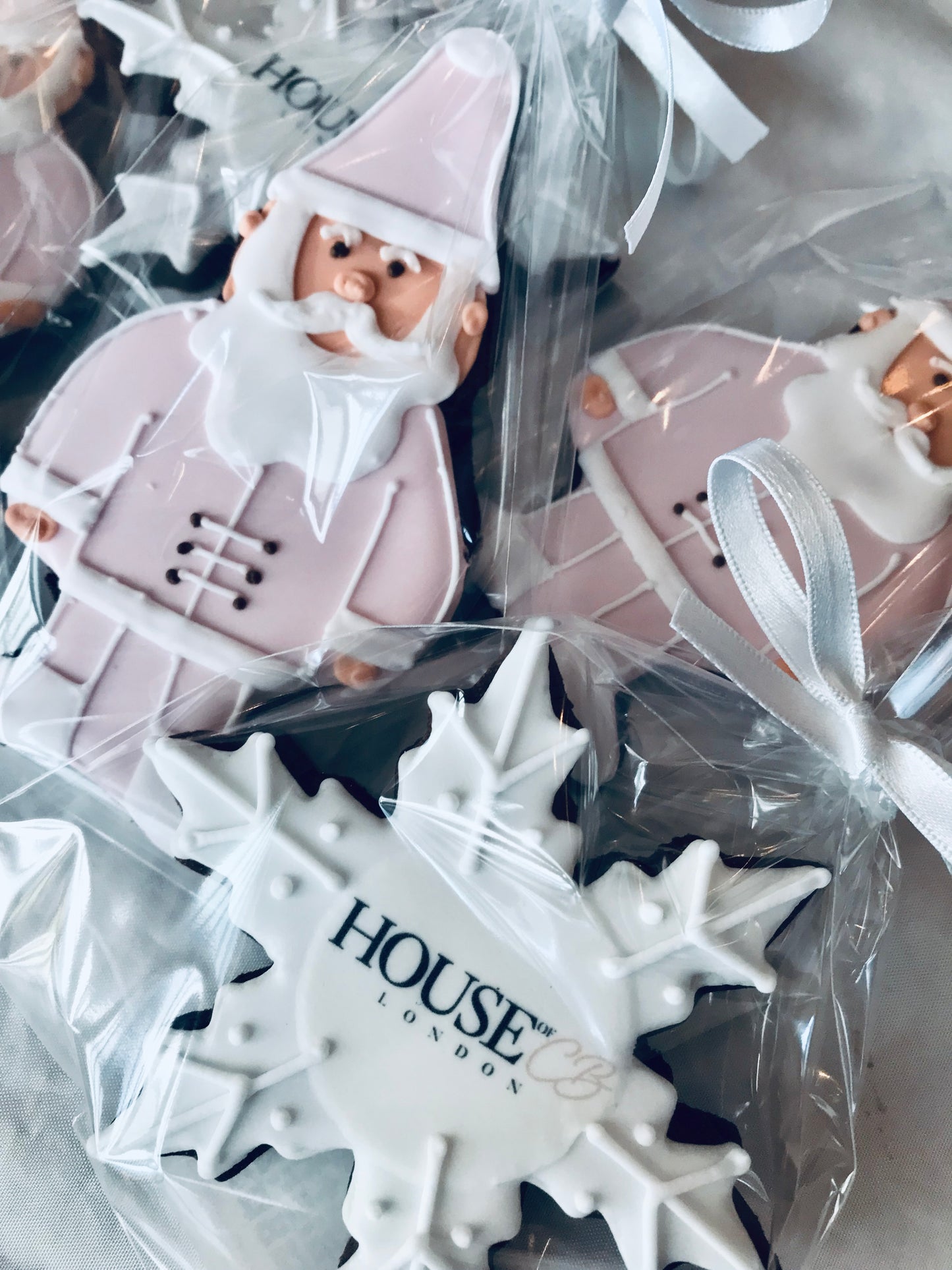 House of CB pink father Christmas cookies. Branded snowflake biscuits. Pink and white Christmas corporate biscuits.