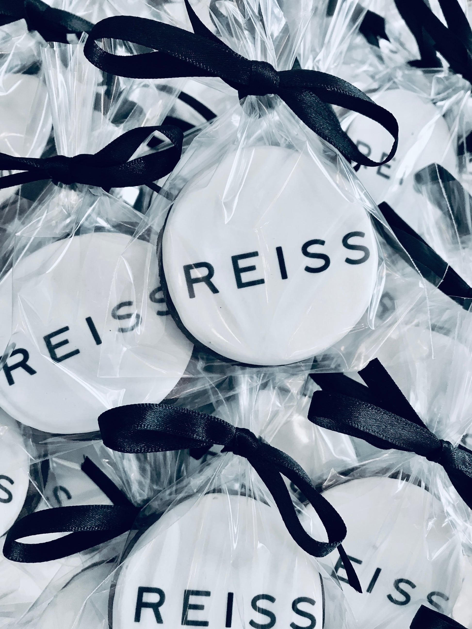 printed Reiss logo biscuits. individually wrapped branded cookies for corporate event.