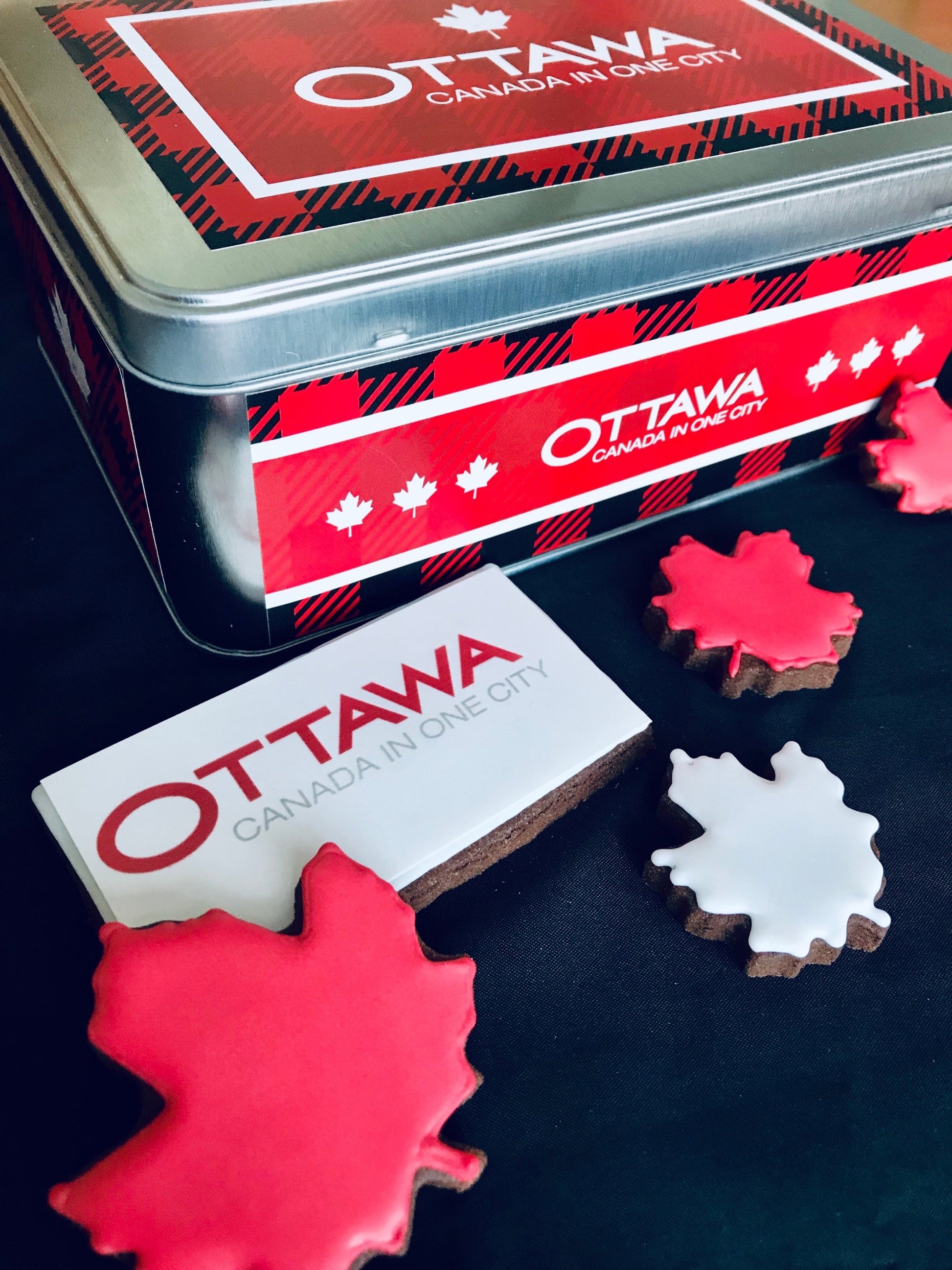 Ottawa cookies. Branded biscuit tin with logo biscuits inside. Canada maple leaf shaped biscuits and printed logo biscuits inside a tin that includes a corporate logo.