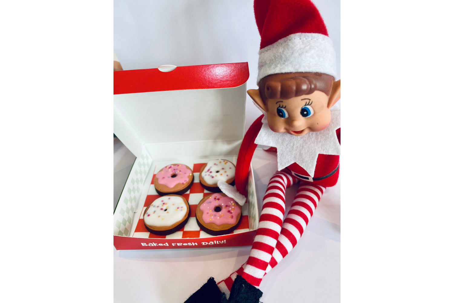 Elf on the shelf mini biscuits to look like Elf doughnuts. mini doughnut cookies in an elf delivery box.