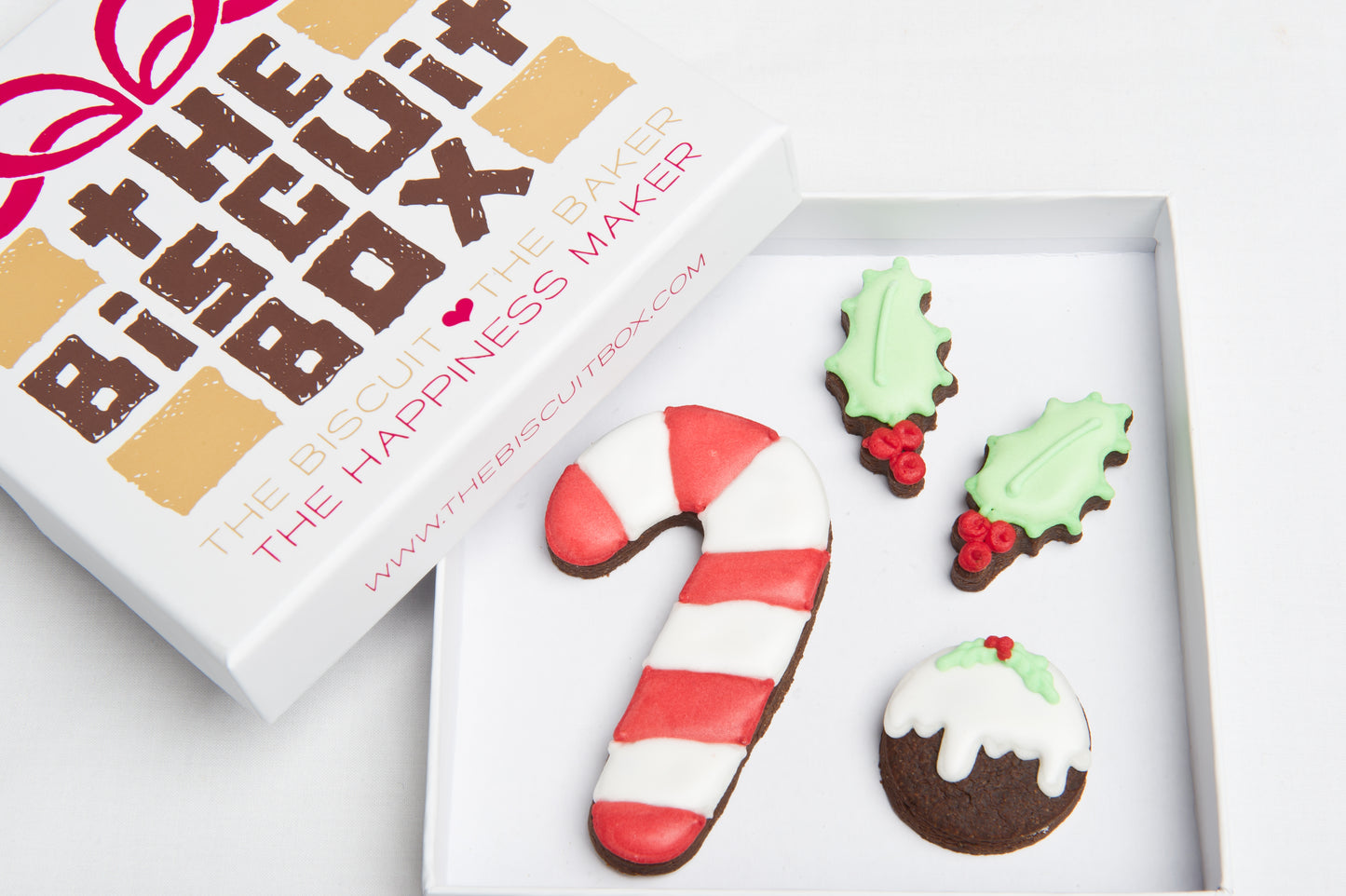 candy cane iced biscuit in a box with mini holly cookie, Christmas mini biscuits. all packaged in a. small box that fits through the letter box.