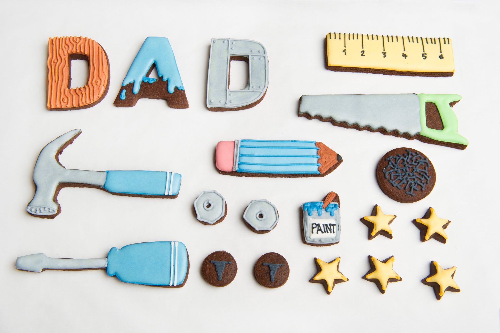 layout image of the biscuits included in the fathers day diy tin. biscuit hammer, cookie screwdriver.