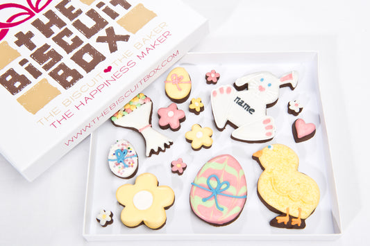 selection of Easter biscuit shapes displayed in shallow box for posting. iced rabbit cookie, bunny biscuit, egg cookie. Iced Easter biscuit designs in a box.