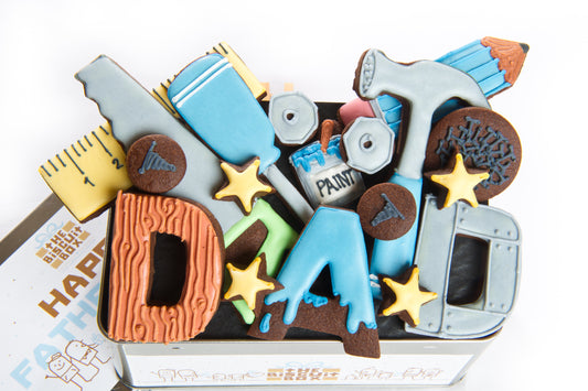 Fathers Day tin of biscuits. Tool cookies and letter biscuits that spell out DAD. Fathers day gift for DIY experts, with biscuit tools in a tin.