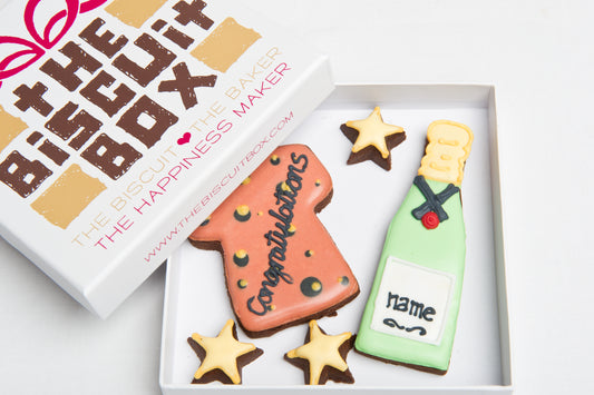 a champagne cookie and cork biscuit to congratulate someone. Congratulations is iced onto the cork and then the Champagne bottle is personalised with a name. mini star cookies are included.