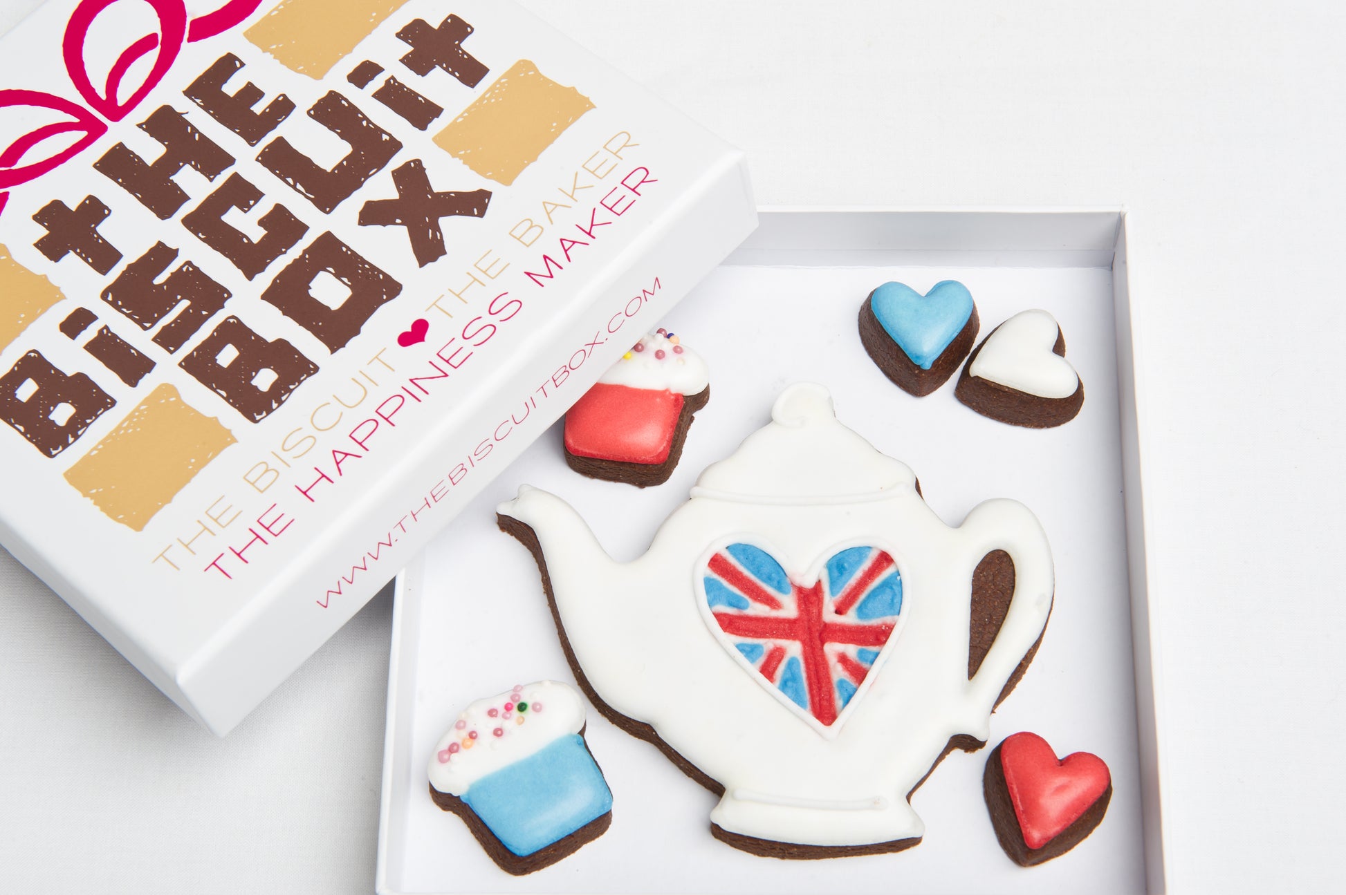 iced white teapot cookie with Union Jack design. Red white and blue mini heart biscuits in a box with tea gift.