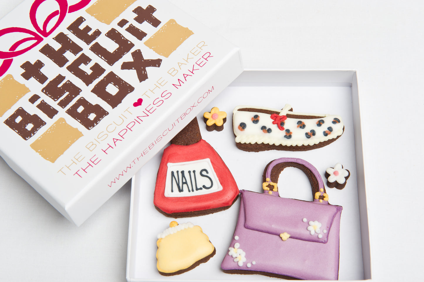 fashion cookies in a box. Handbag biscuits and show biscuits with mini iced hearts in a box to fit through the letterbox.